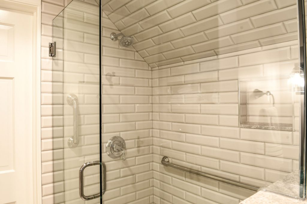 Louisville Kentucky Home Renovation, Louisville Kentucky Attic Renovation, Castlerock, Guest Suite, En Suite Bath, Sweet Retreat, Bedroom, Bathroom Addition, En Suite Bathroom, Sitting Area, Gray Wall Color, Antique Furniture, Built In Shelving, Gray Subway Tile, Chrome Finishes, White Built In Shelving, Granite Vanity Top, White Vanity, Vanity Lighting, Glassed In Shower, Hinged Door Shower, Large Shower, Marble Tile Flooring, Stairway, Before and After