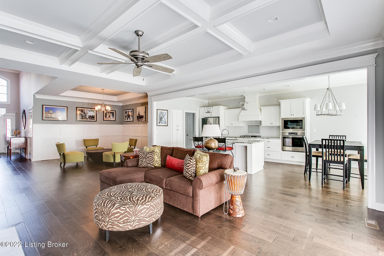 open concept floorplan, contemporary furniture, zebra print, home staging, engineered hardwood floors, black kitchen table and chairs, coffered ceiling, circular seating